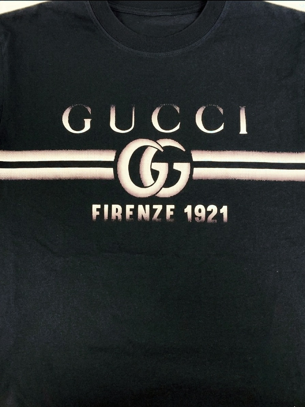 Gucci Black Tee with Faded White Logo and Stripes.